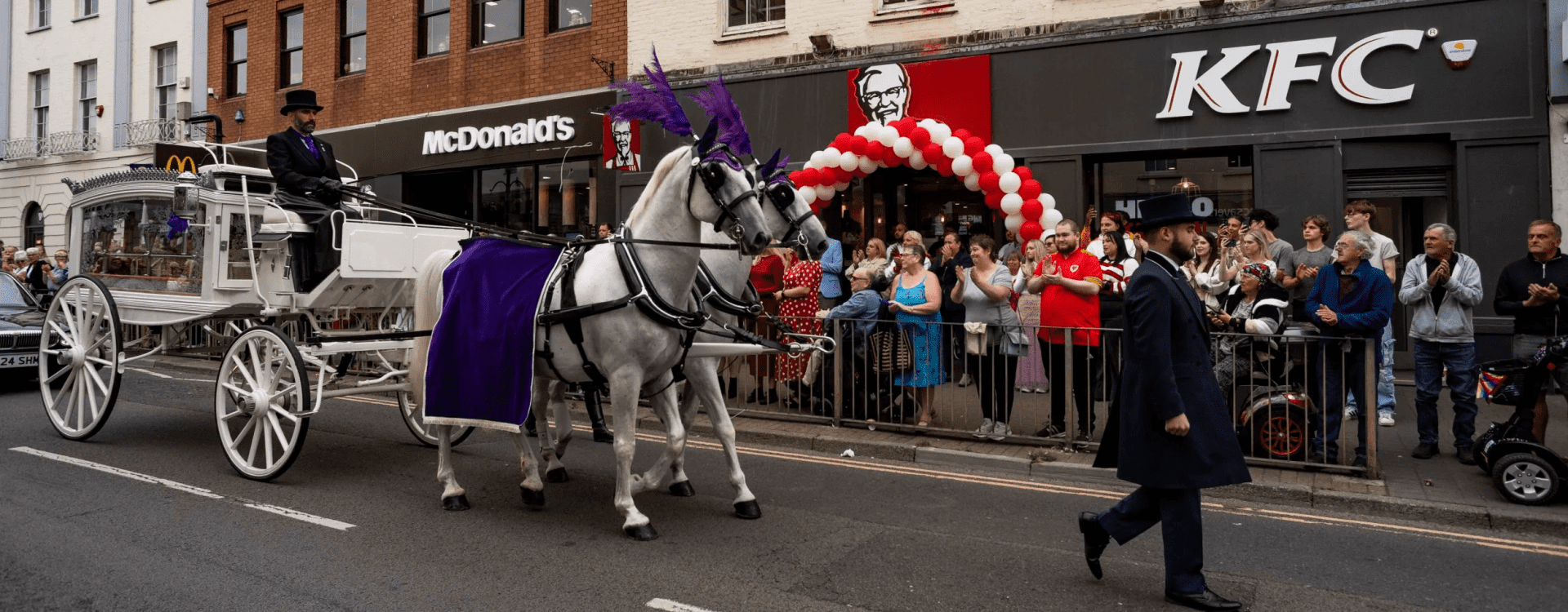 A traditional horse drawn funeral service
